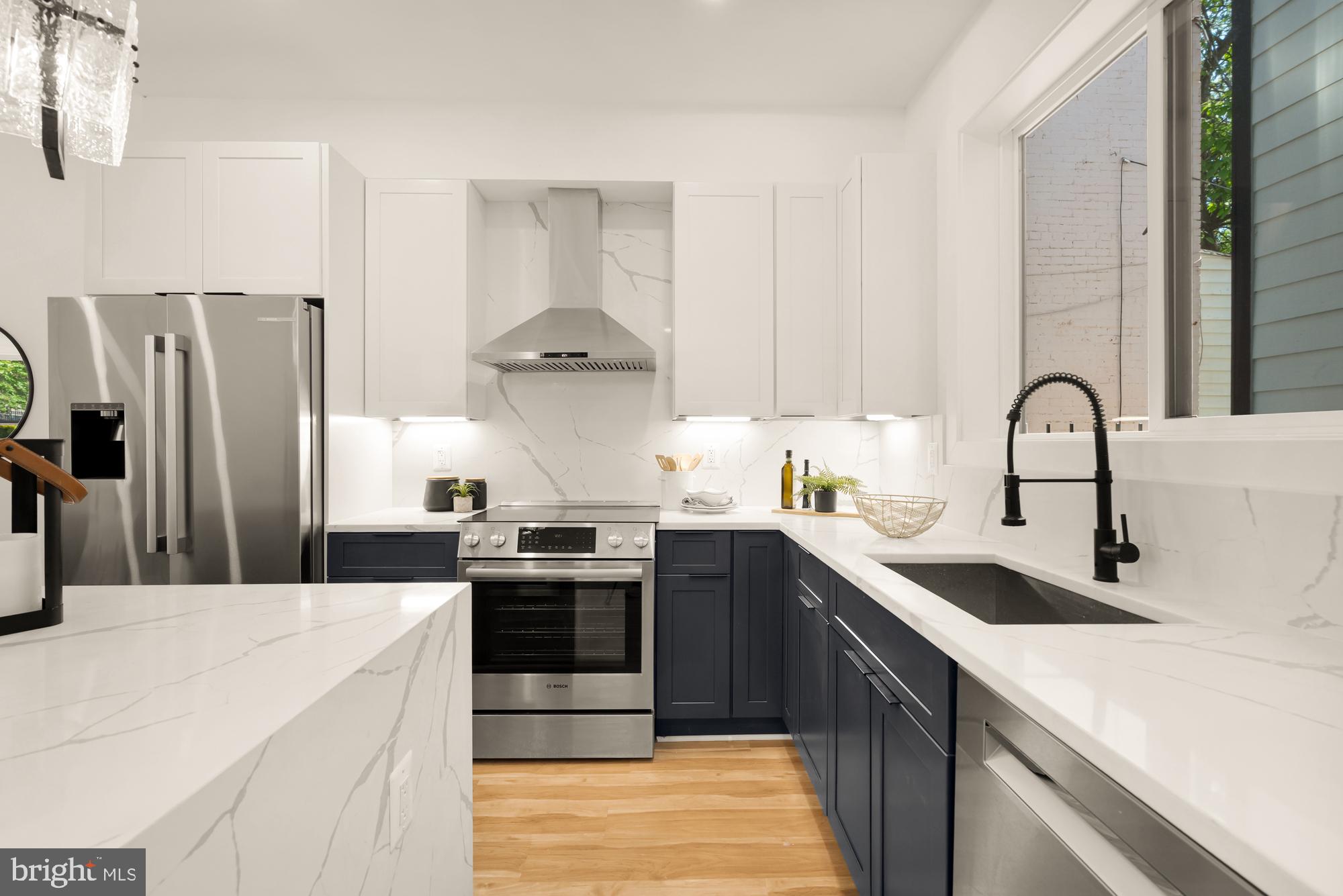 1251 Morse Street Northeast, Unit B Washington, DC 20002 - Photo 13 of 37 a kitchen with stainless steel appliances granite countertop a sink stove and refrigerator