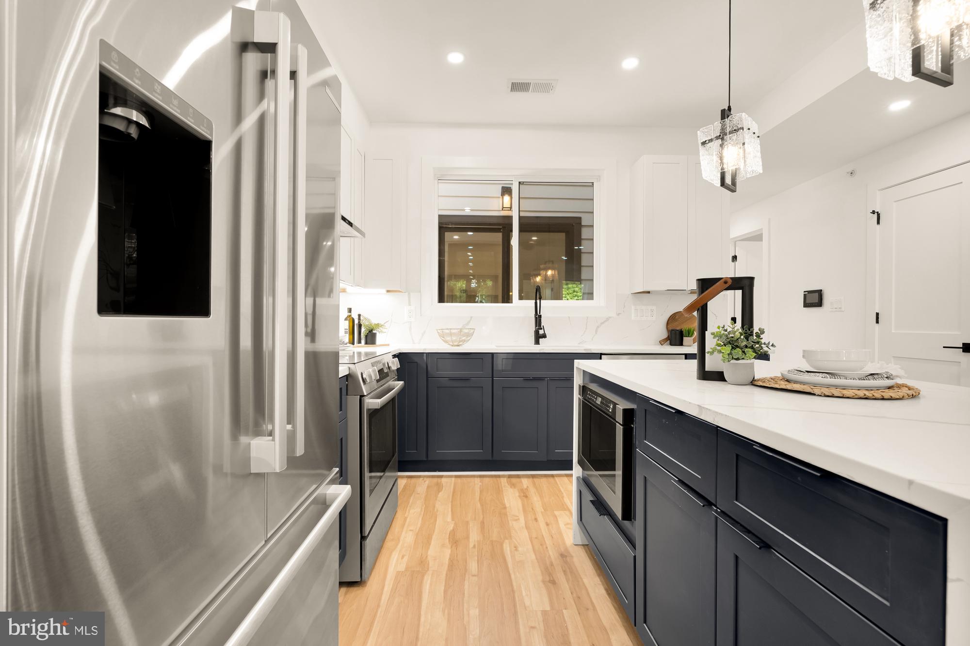 1251 Morse Street Northeast, Unit B Washington, DC 20002 - Photo 14 of 37 a kitchen with a sink appliances and cabinets