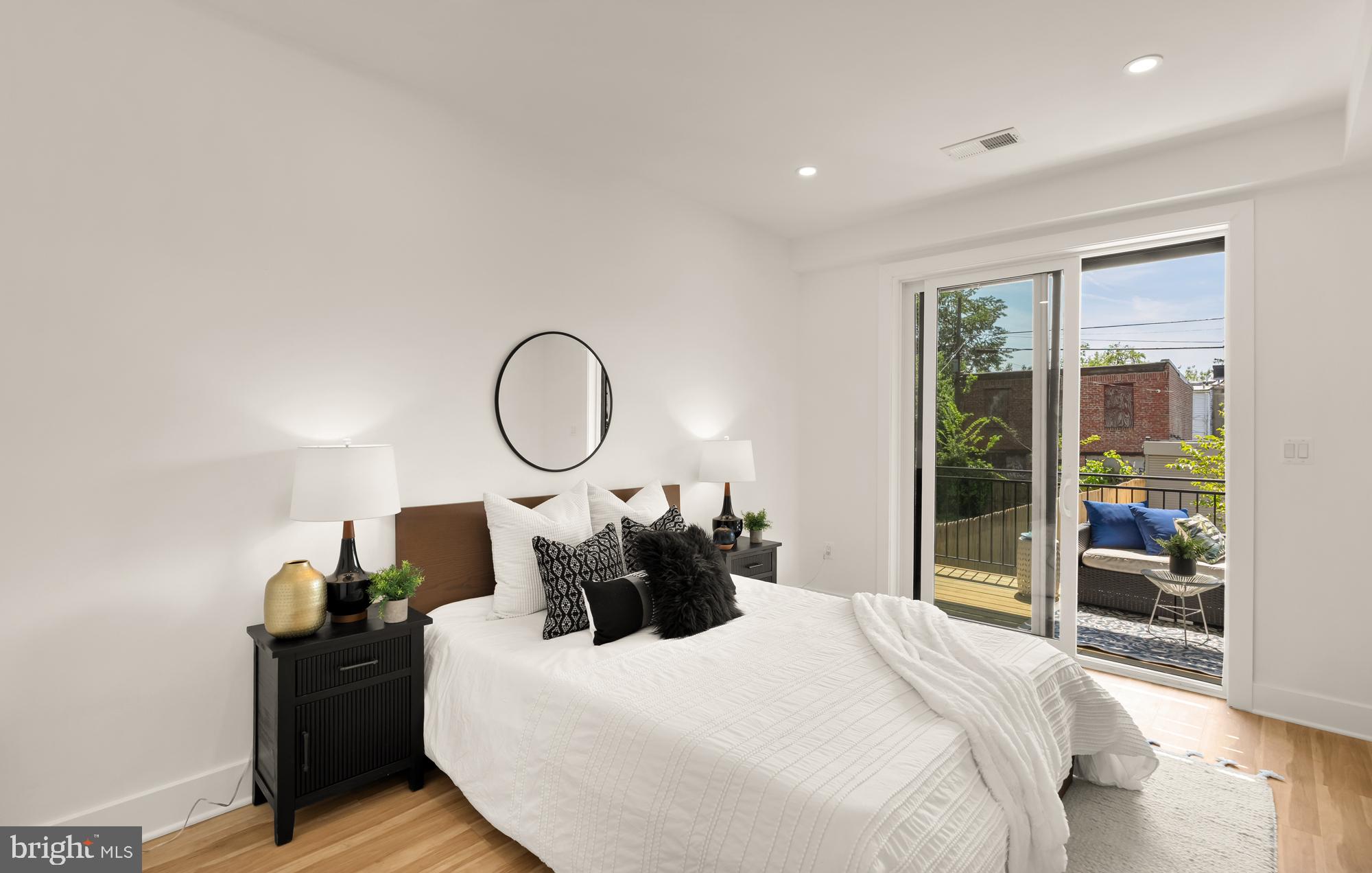 1251 Morse Street Northeast, Unit B Washington, DC 20002 - Photo 23 of 37 a bedroom with a bed and a large mirror