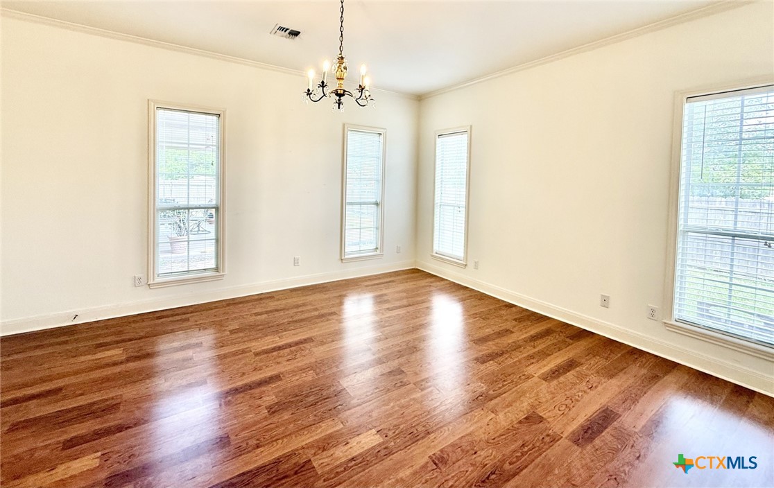 415 South Trinity Street Edna, TX 77957 - Photo 23 of 46 a view of an empty room with wooden floor and a window