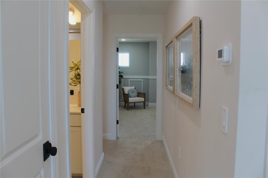 17706 Broadleaf Loop Venice, FL 34293 - Photo 13 of 16 a view of a bathroom from a hallway