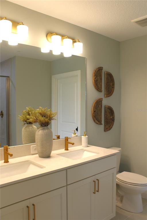 17706 Broadleaf Loop Venice, FL 34293 - Photo 7 of 16 a bathroom with a sink and a mirror