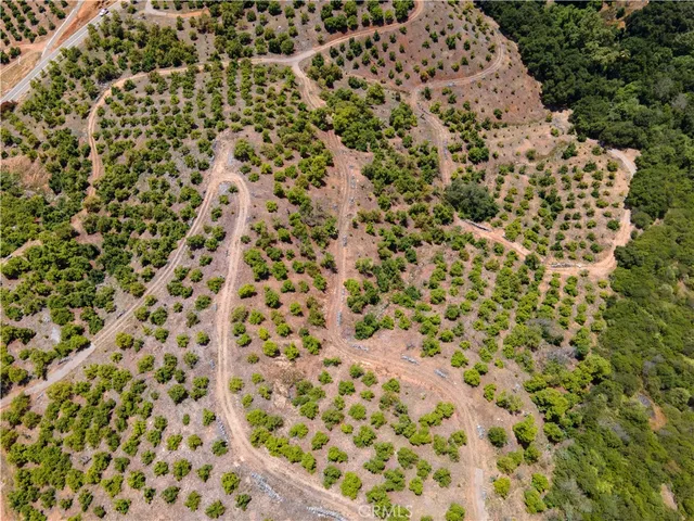 an aerial view of house with yard and mountain view
