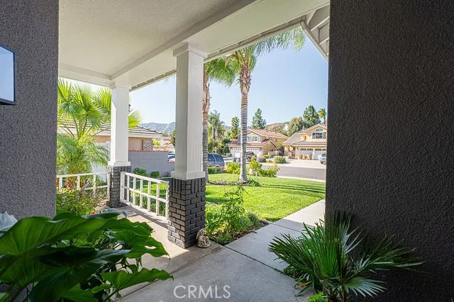 a view of a pathway with house with potted plants in front of main door