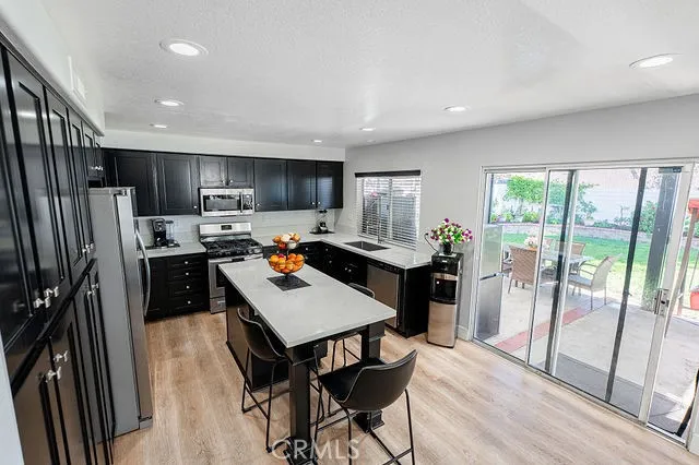 a kitchen with stainless steel appliances a stove a microwave and cabinets