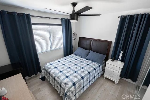 a bedroom with a bed and wooden floor