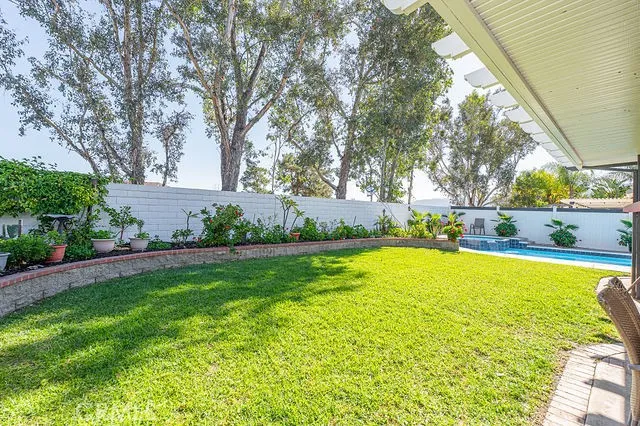 a view of a house with a yard and sitting area