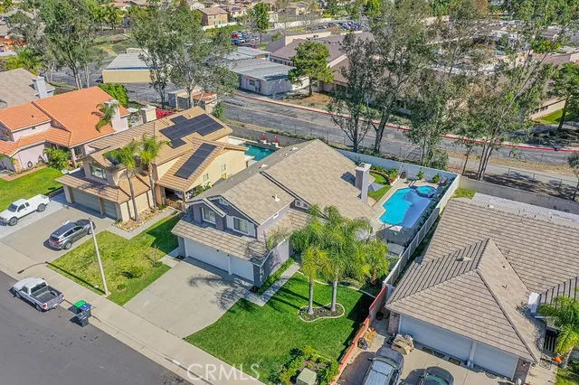 an aerial view of a house with a garden and trees