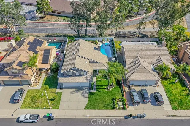 an aerial view of a house with garden space and street view