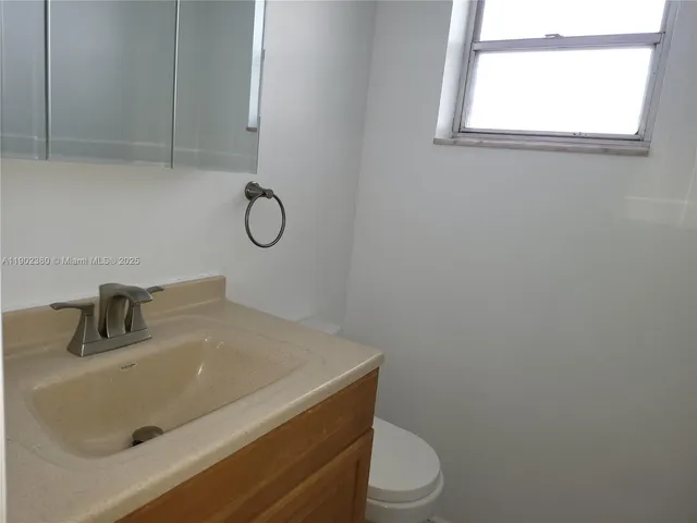 a bathroom with a sink toilet and vanity