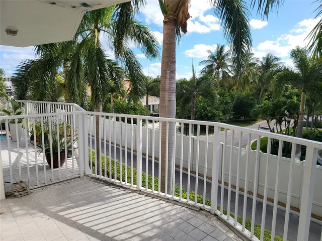 a view of a wooden fence under a palm tree