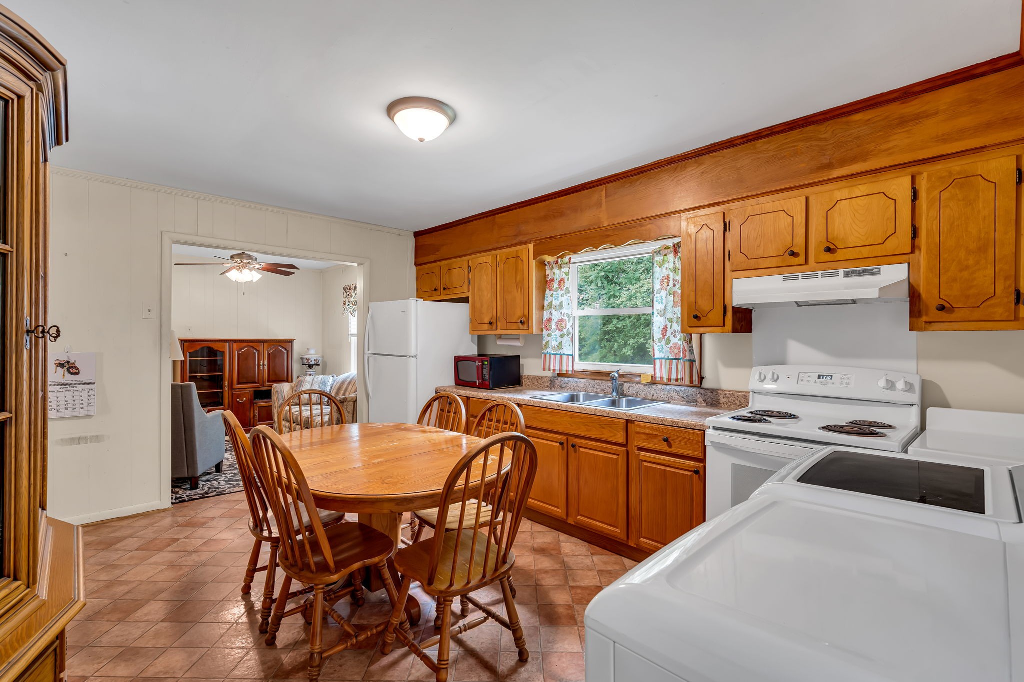 390 Southside Road Cunningham, TN 37052 - Photo 13 of 22 a kitchen with a table chairs refrigerator and cabinets