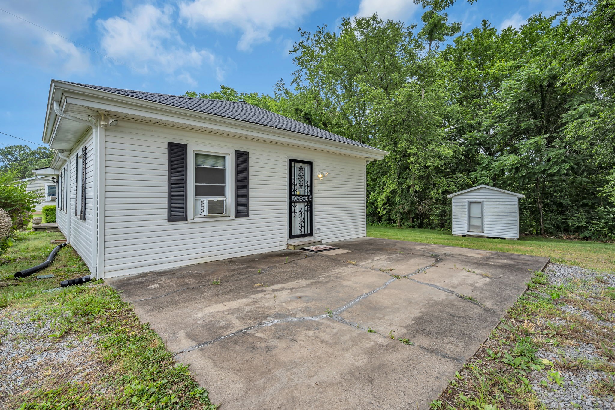 390 Southside Road Cunningham, TN 37052 - Photo 3 of 22 a backyard of a house with a garden and entertaining space