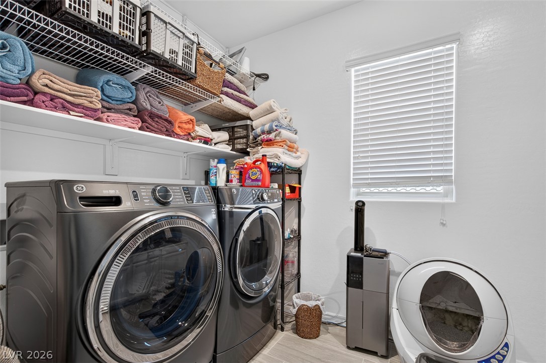 1824 Redland Ridge Street Henderson, NV 89002 - Photo 55 of 69 A dedicated laundry space offers practical storage and modern appliances for efficient home management.