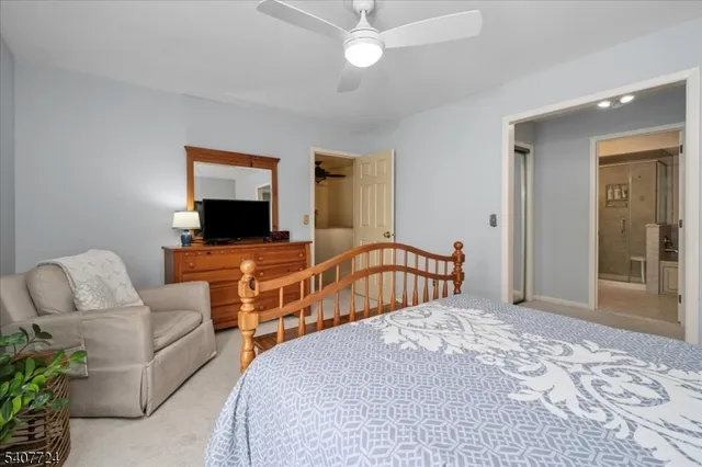 a bedroom with furniture and a flat screen tv