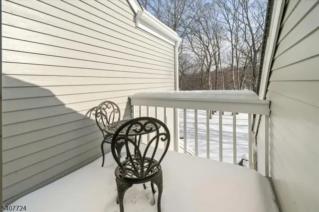 a view of a chair and table in backyard