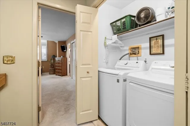 a view of storage and utility room with washer and dryer