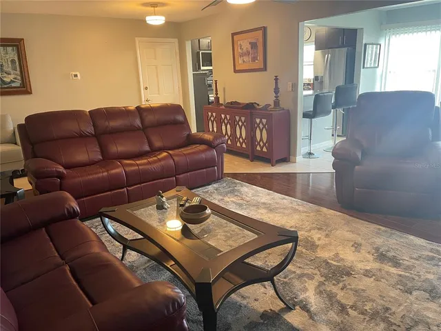 a bedroom with a bed and a dresser next to a window