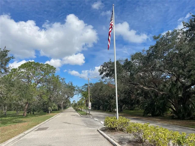 a street sign on a sidewalk next to a road