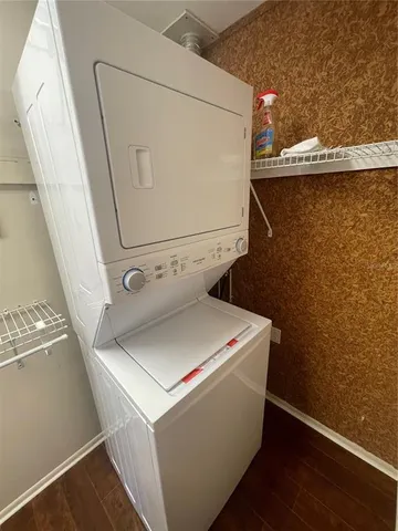 a view of a white house with a big yard potted plants and a fountain