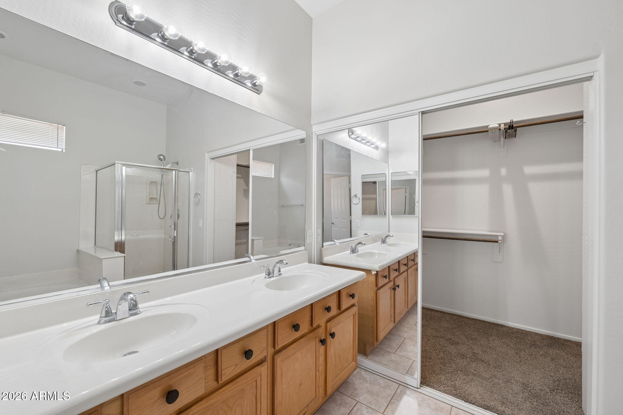 4418 East Jaeger Road Phoenix, AZ 85050 - Photo 17 of 42 a bathroom with a double vanity sink and mirror