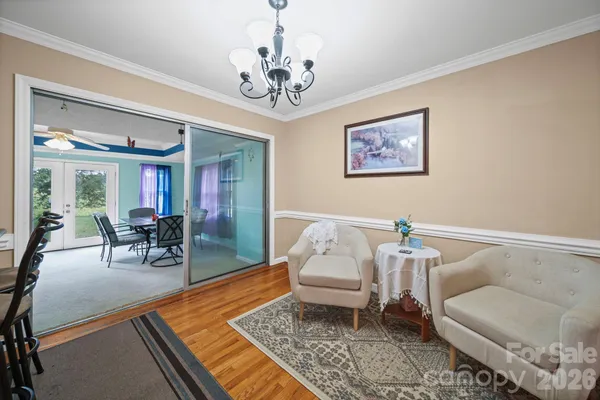 a living room with furniture and a chandelier
