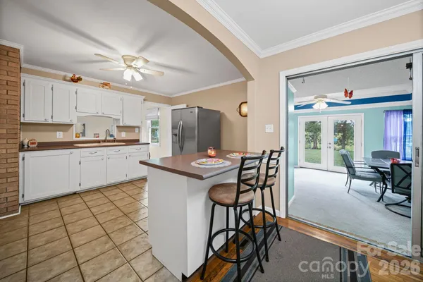 a kitchen with stainless steel appliances kitchen island granite countertop a sink and cabinets