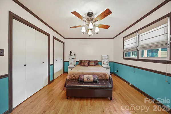 a bed room with furniture and window