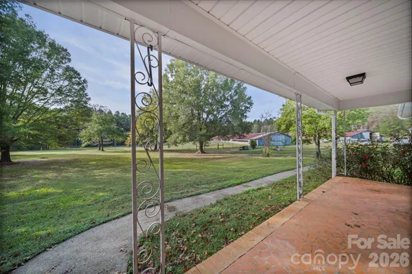 a view of a house with a big yard and potted plants