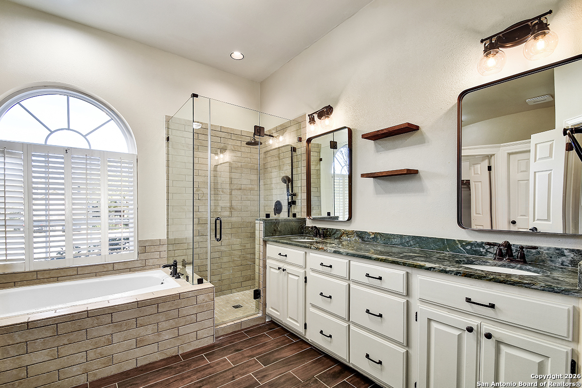 2642 Rim Oak San Antonio, TX 78232 - Photo 12 of 24 a spacious bathroom with double vanity a mirror a bathtub and a shower