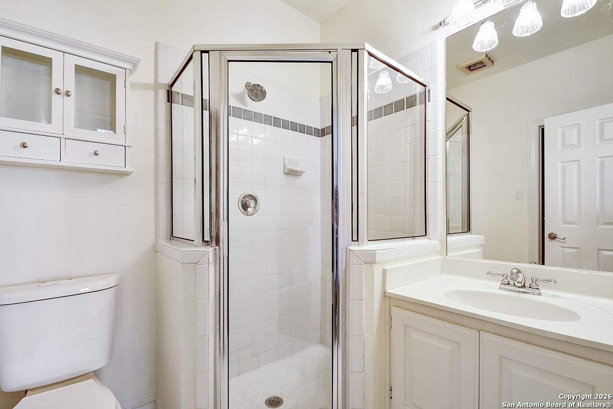 2642 Rim Oak San Antonio, TX 78232 - Photo 20 of 24 a bathroom with a shower sink vanity and mirror