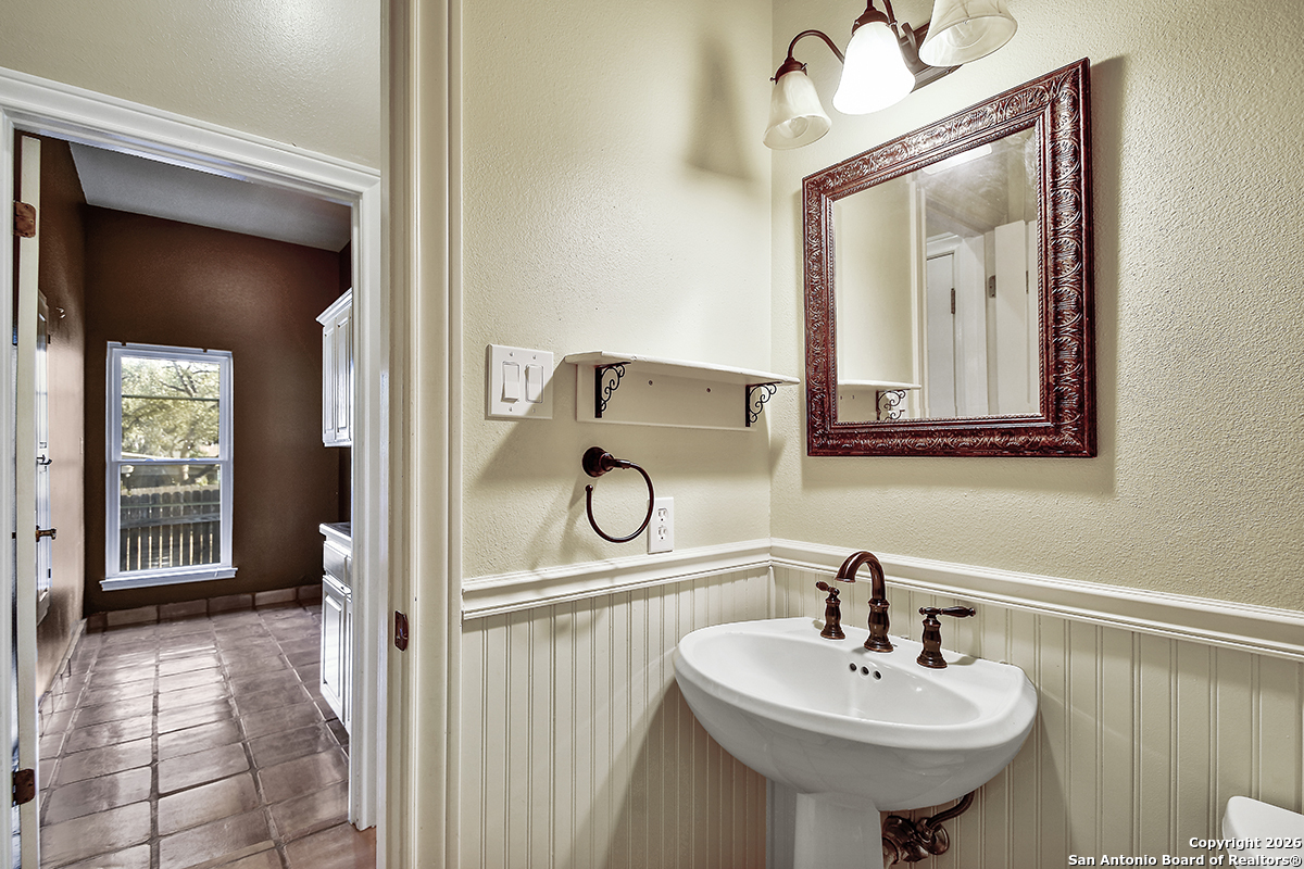 2642 Rim Oak San Antonio, TX 78232 - Photo 22 of 24 a bathroom with a sink a mirror and vanity