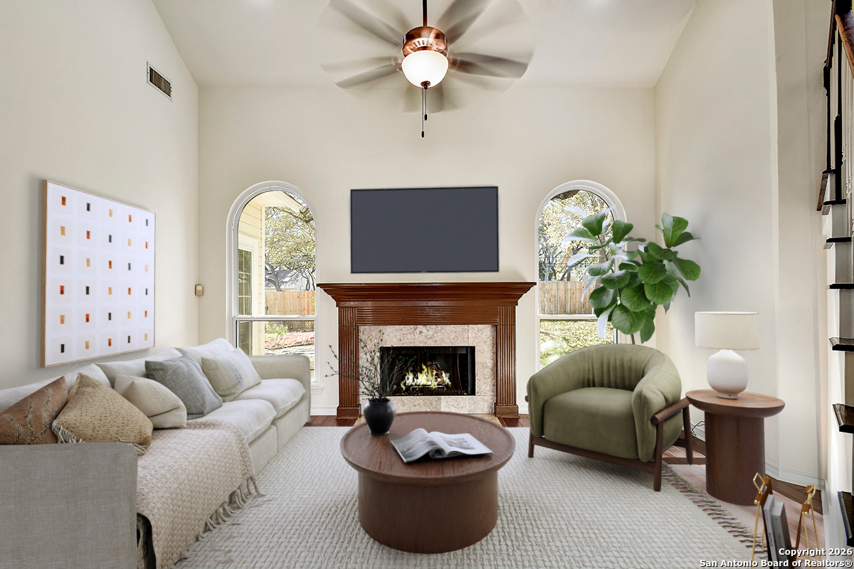 2642 Rim Oak San Antonio, TX 78232 - Photo 3 of 24 a living room with furniture a fireplace and a potted plant