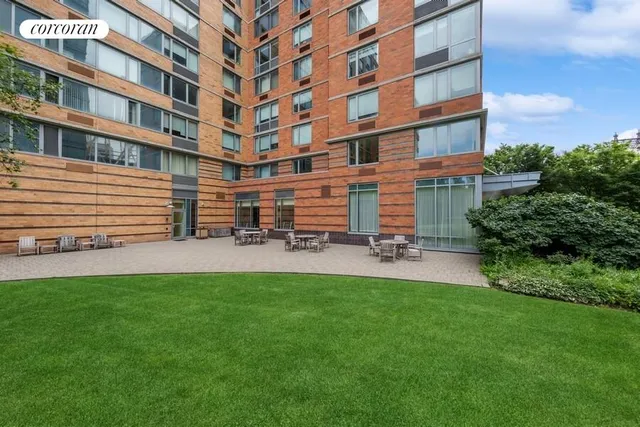 a front view of a building with a garden