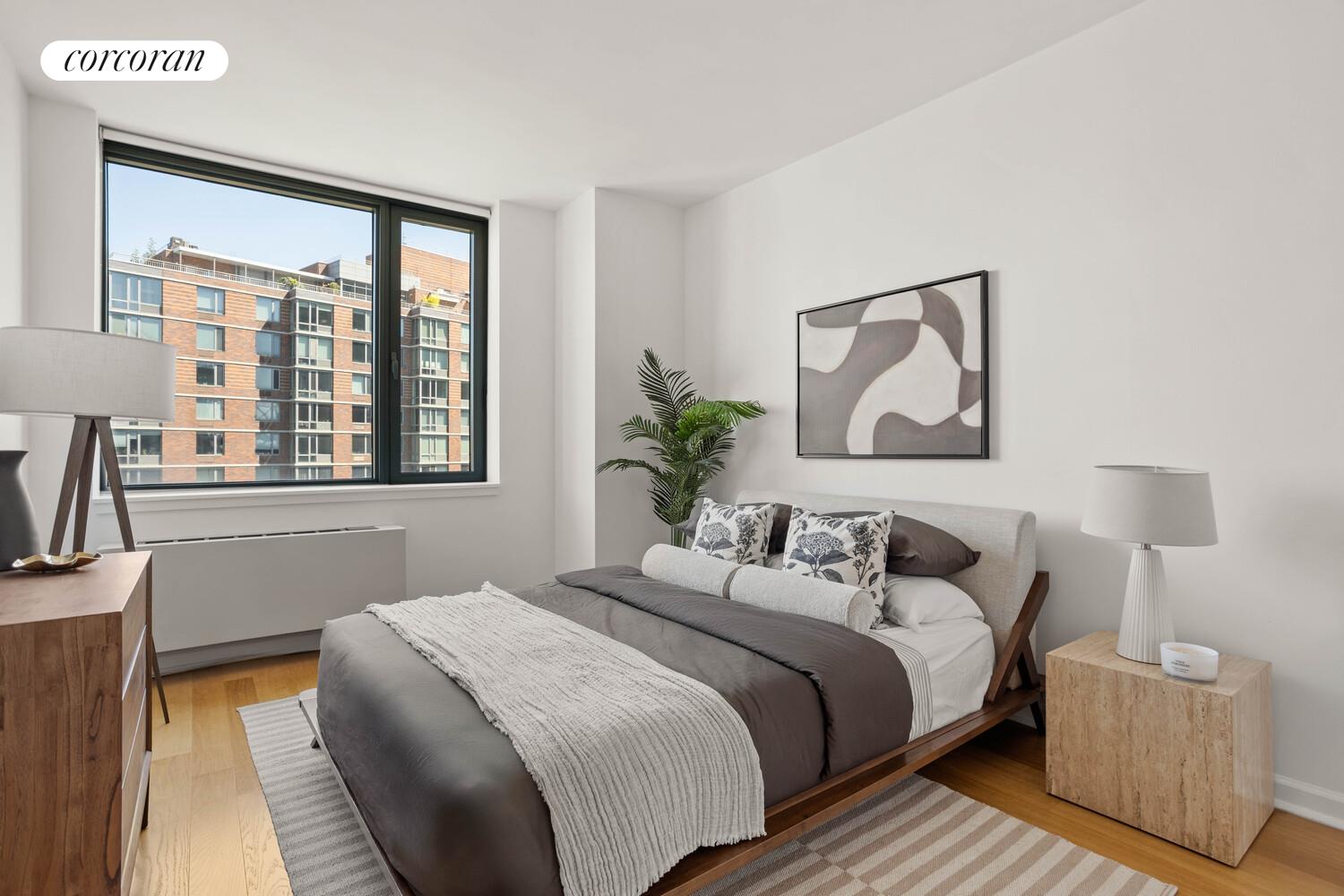 425 Main Street, Unit 14C Manhattan, NY 10044 - Photo 3 of 23 a bedroom with a bed and a painting on the wall