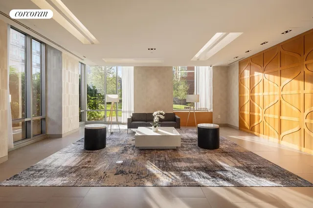 a living room with furniture windows and a potted plant
