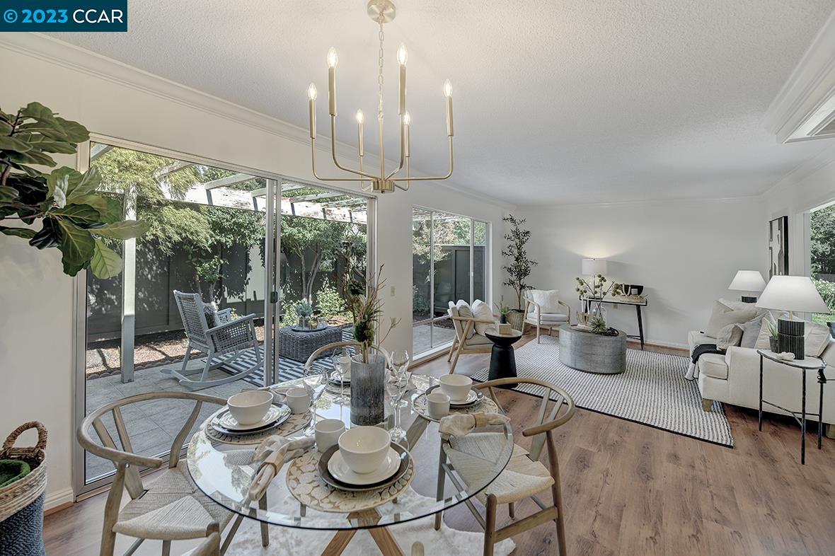 a view of a dining room with furniture large windows and wooden floor