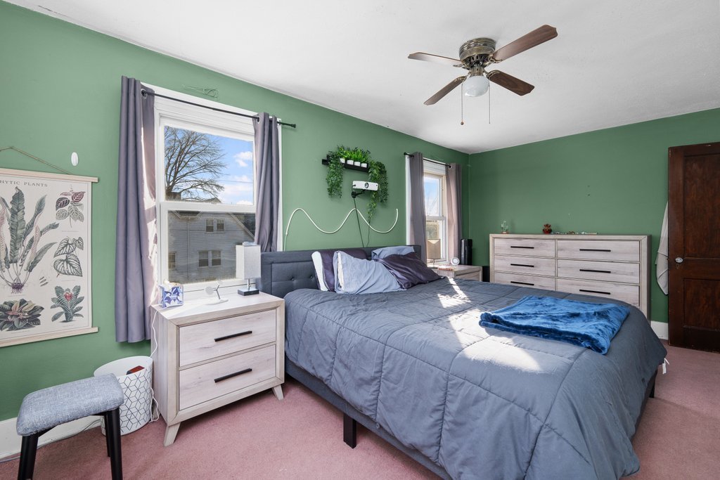 2545 18th Avenue A Moline, IL 61265 - Photo 20 of 28 a bedroom with a bed and a chandelier