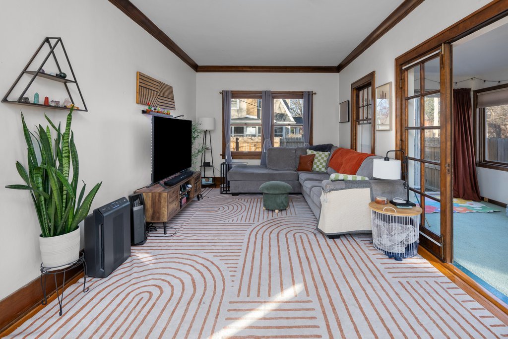 2545 18th Avenue A Moline, IL 61265 - Photo 4 of 28 a living room with furniture a flat screen tv and a floor to ceiling window
