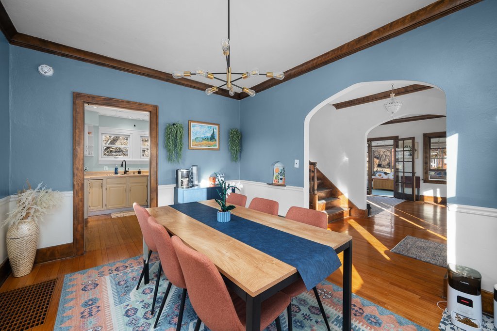 2545 18th Avenue A Moline, IL 61265 - Photo 7 of 28 a dining room with wooden floor a chandelier a wooden table and chairs