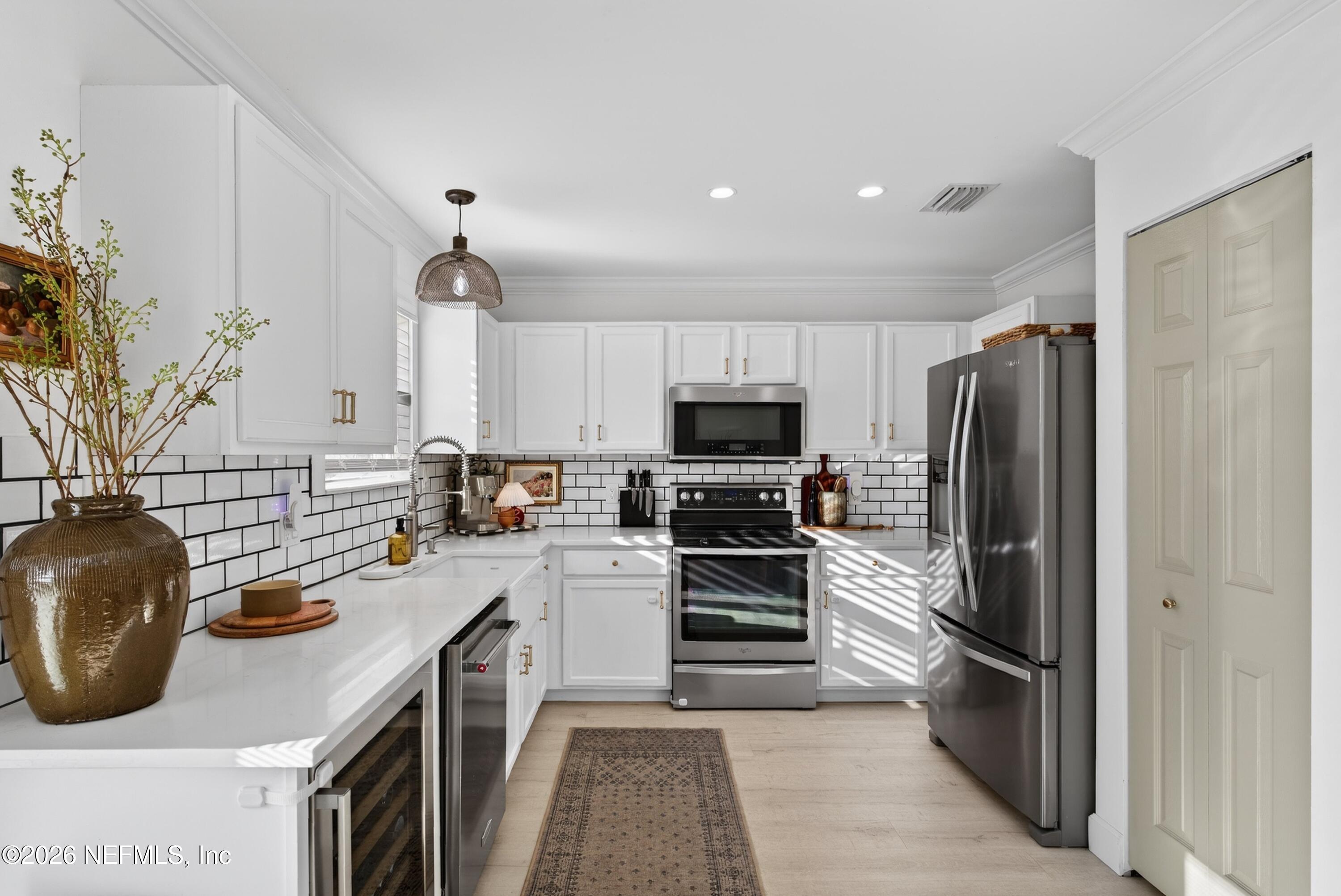 1110 Scheidel Court Atlantic Beach, FL 32233 - Photo 12 of 24 a kitchen with a refrigerator and a stove top oven