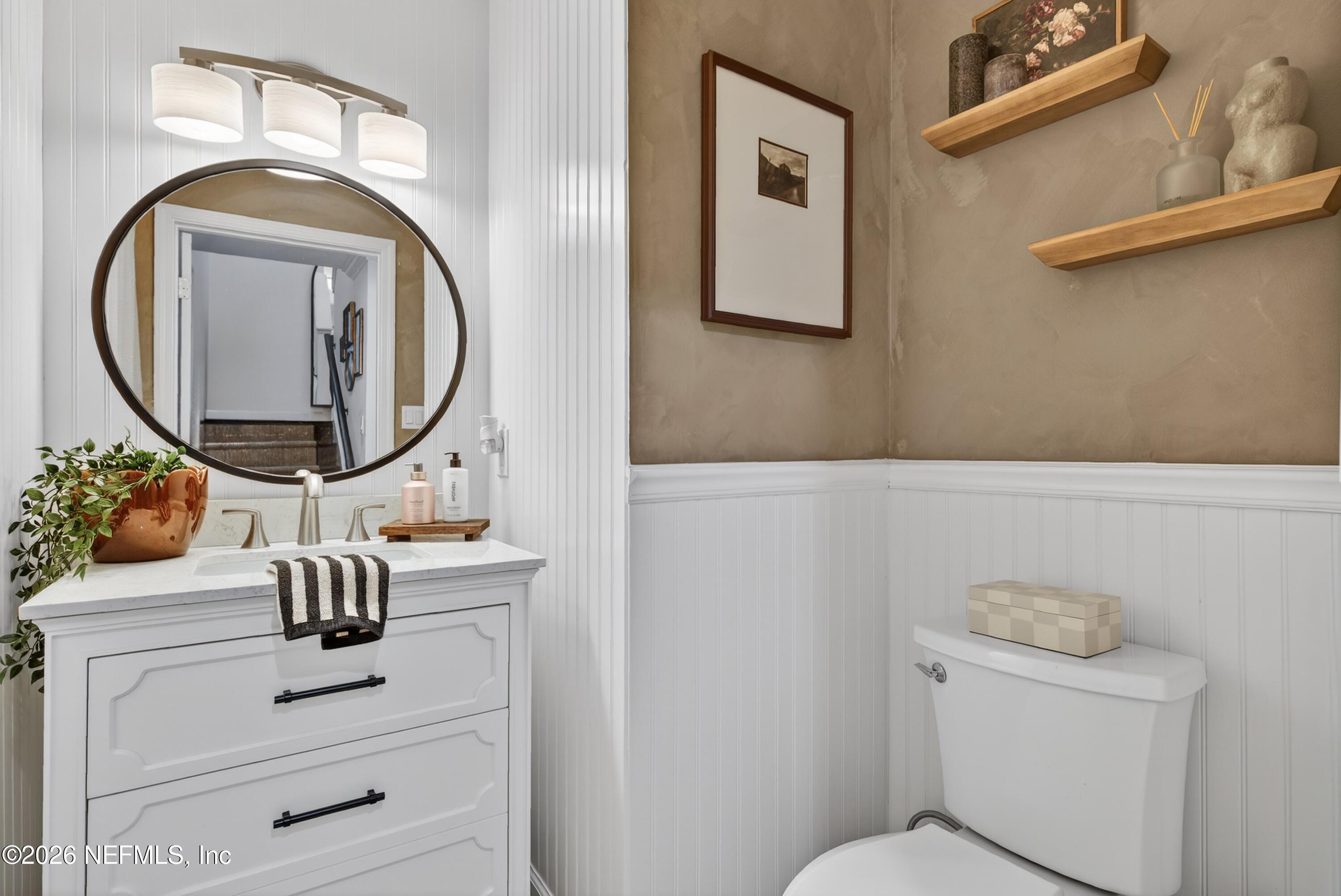 1110 Scheidel Court Atlantic Beach, FL 32233 - Photo 17 of 24 a bathroom with a toilet mirror and vanity