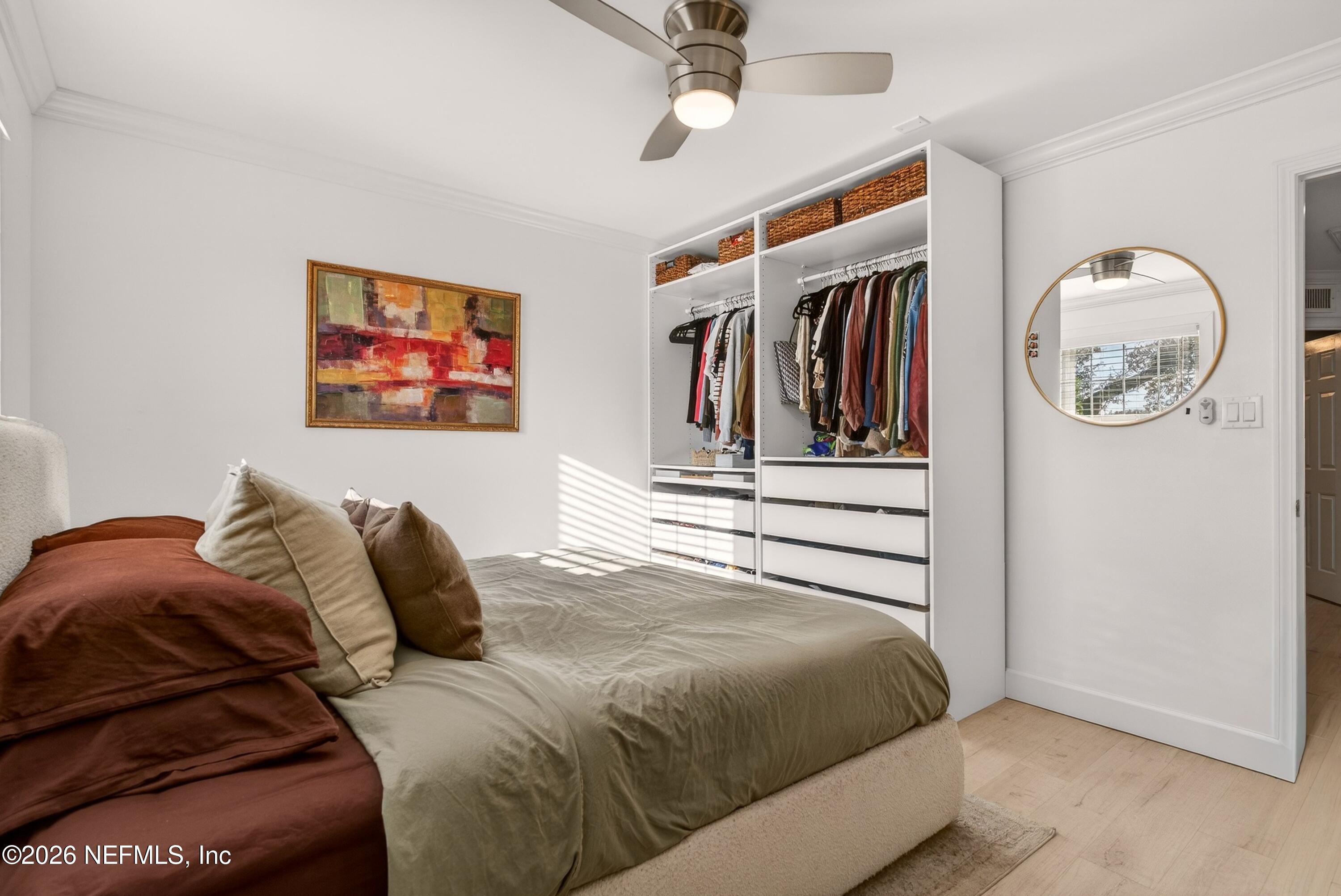 1110 Scheidel Court Atlantic Beach, FL 32233 - Photo 19 of 24 a bedroom with a bed and a painting on the wall