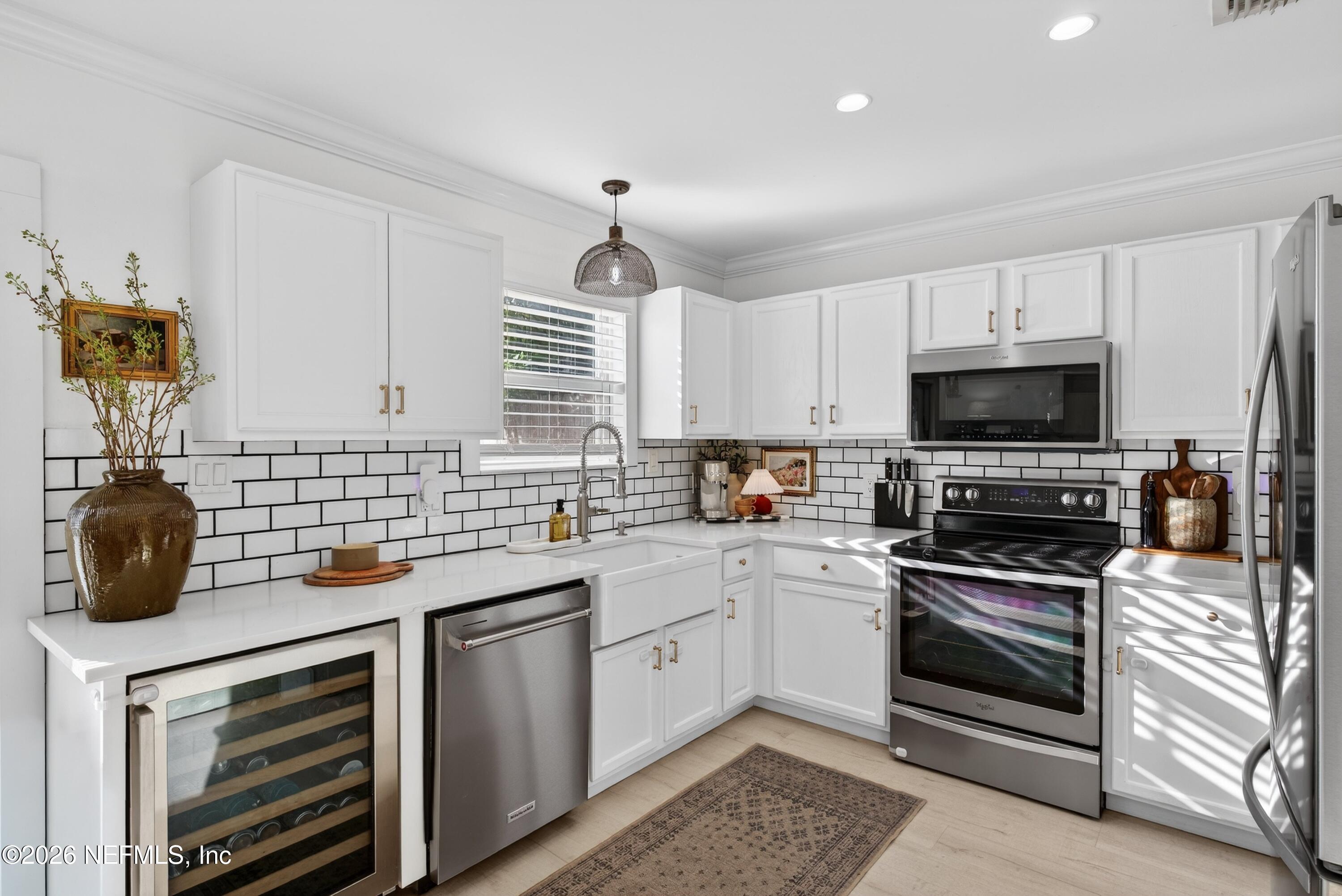 1110 Scheidel Court Atlantic Beach, FL 32233 - Photo 3 of 24 a kitchen with a sink appliances and cabinets