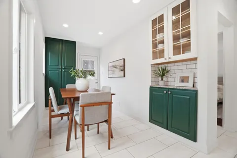 a dining room with furniture and window