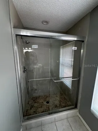a bathroom with a glass shower door