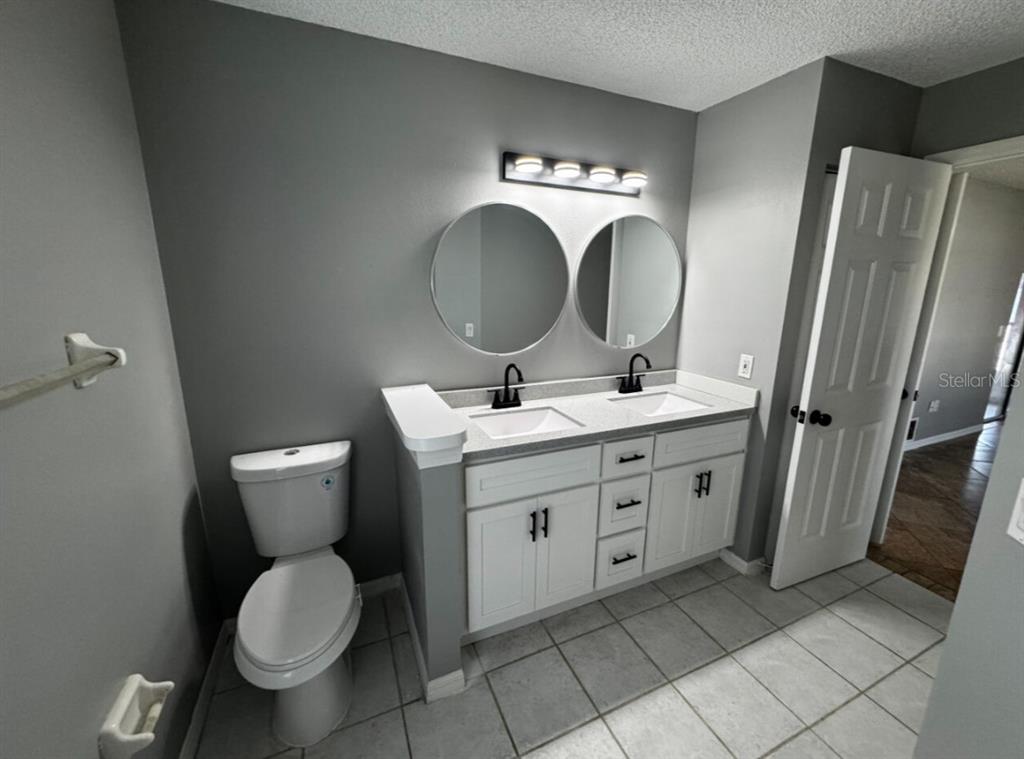 7854 Southwest 62nd Court Ocala, FL 34476 - Photo 7 of 18 a bathroom with a toilet sink and mirror