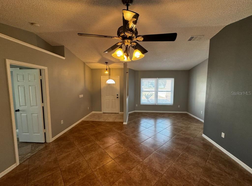 7854 Southwest 62nd Court Ocala, FL 34476 - Photo 9 of 18 a view of an empty room and window and chandelier fan