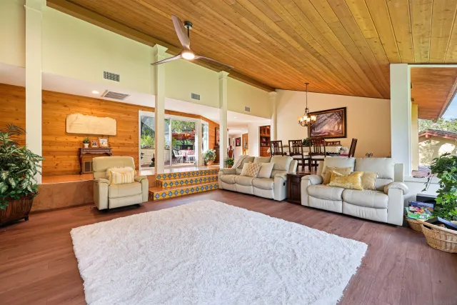 a bedroom with furniture and a large window