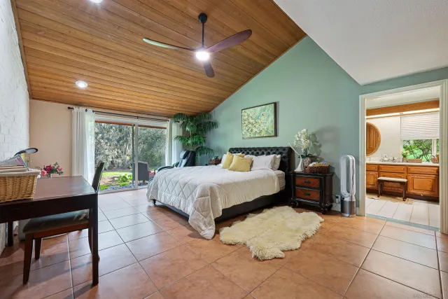 a bedroom with a bed and a view of balcony